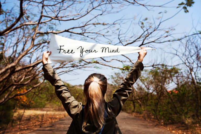 girl-holding-free-your-mind-flag-banner