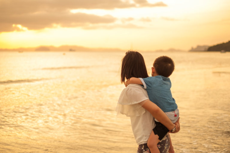 mother-son-outdoors-sunset-with-copy-space