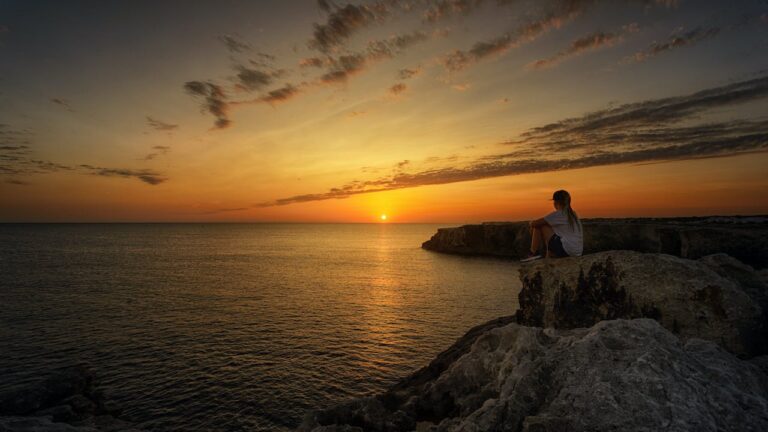 sunset sitting on rocks